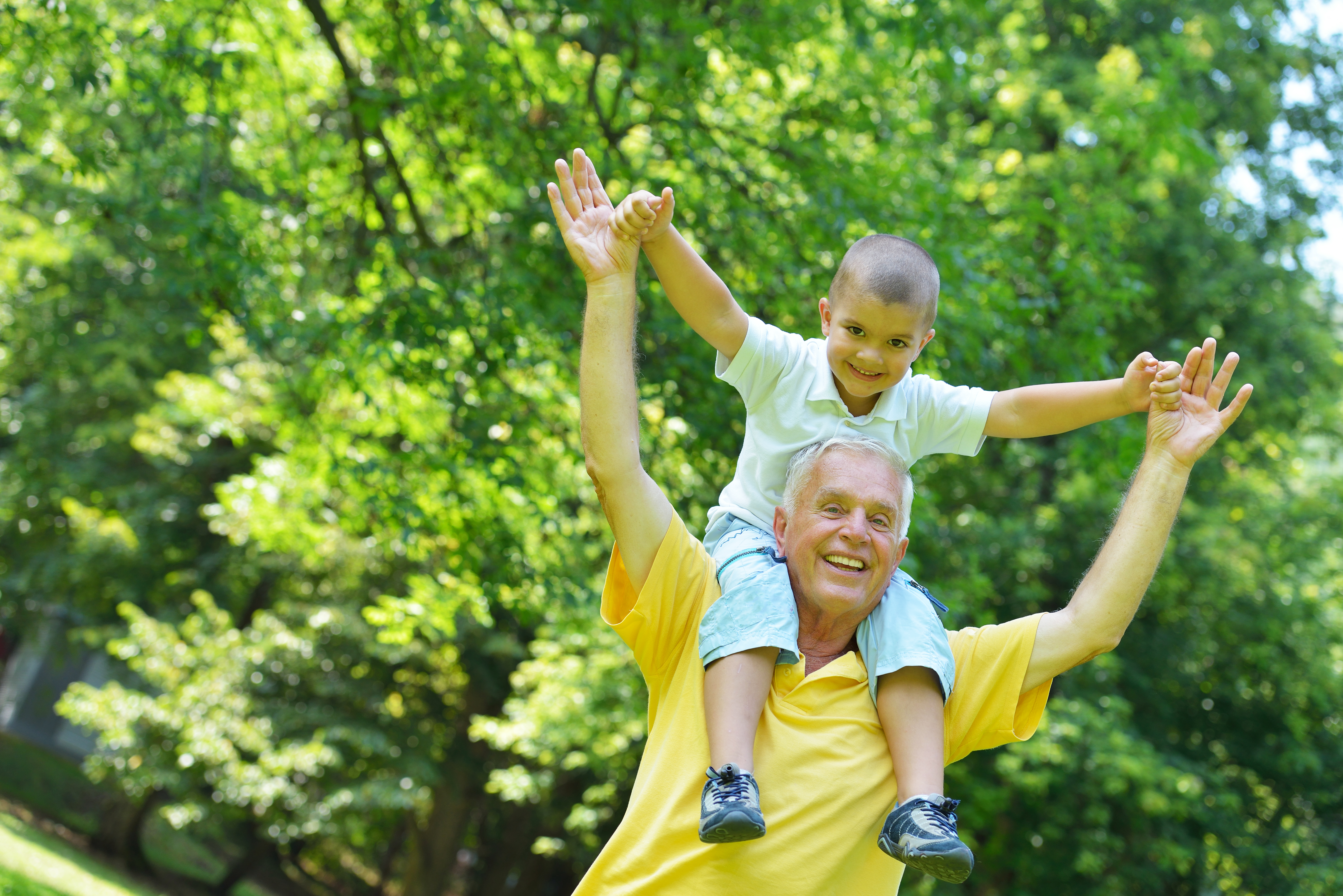 happy-grandfather-and-child-in-park-SBI-300818271